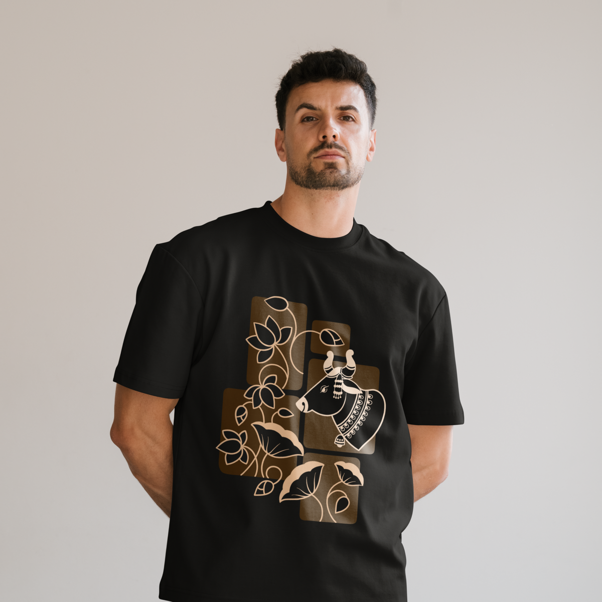 a desi cow illustration in the front of a free size round neck T-Shirt worn by a male with light grey background. 